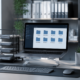 Organized office workspace with labeled file folders, digital file management on a computer, and document organization system